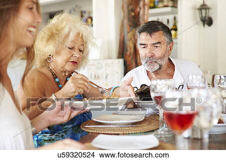 Multi Generation Family Enjoying Meal In Restaurant View Large Photo Image Picture - Multi Generation Family Enjoying Meal In Restaurant. Fotosearch