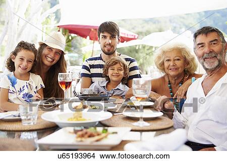 Picture - Multi Generation Family Enjoying Meal In Restaurant. Fotosearch