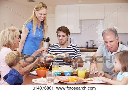 Multi Generation Family Enjoying Meal At Home Together View Large Photo Image Stock Image - Multi Generation Family Enjoying Meal At Home Together. Fotosearch