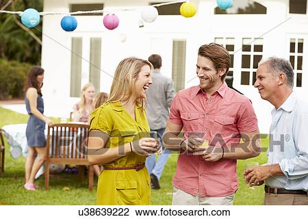 Multi Generation Family Enjoying Meal In Garden Together View Large Photo Image Stock Image - Multi Generation Family Enjoying Meal In Garden Together. Fotosearch