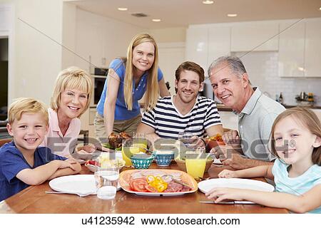 Multi Generation Family Enjoying Meal At Home Together View Large Photo Image Stock Image - Multi Generation Family Enjoying Meal At Home Together. Fotosearch
