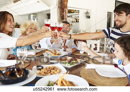 Multi Generation Family Enjoying Meal In Restaurant View Large Photo Image Stock Image - Multi Generation Family Enjoying Meal In Restaurant. Fotosearch