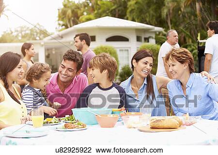 Multi Generation Family Enjoying Meal In Garden Together View Large Photo Image Stock Image - Multi Generation Family Enjoying Meal In Garden Together. Fotosearch