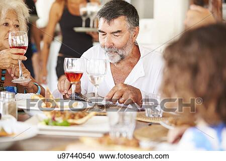 Multi Generation Family Enjoying Meal In Restaurant View Large Photo Image Stock Image - Multi Generation Family Enjoying Meal In Restaurant. Fotosearch