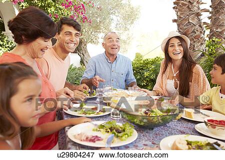 Multi Generation Family Enjoying Meal On Terrace Together View Large Photo Image Stock Photo - Multi Generation Family Enjoying Meal On Terrace Together. Fotosearch