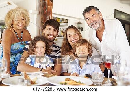 Stock Photography - Multi Generation Family Enjoying Meal In Restaurant. Fotosearch