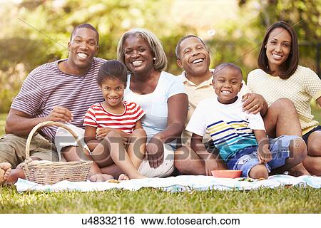 Multi Generation Family Enjoying Picnic In Garden Together View Large Photo Image Stock Photograph - Multi Generation Family Enjoying Picnic In Garden Together. Fotosearch
