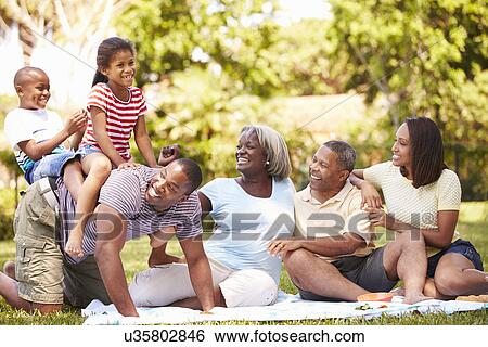 Multi Generation Family Having Fun In Garden Together View Large Photo Image Stock Photograph - Multi Generation Family Having Fun In Garden Together. Fotosearch