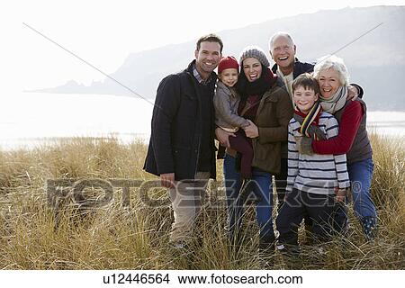 Multi Generation Family In Sand Dunes On Winter Beach View Large Photo Image Picture - Multi Generation Family In Sand Dunes On Winter Beach. Fotosearch