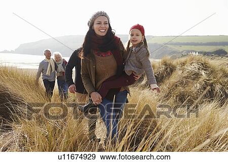 Multi Generation Family In Sand Dunes On Winter Beach View Large Photo Image Stock Photo - Multi Generation Family In Sand Dunes On Winter Beach. Fotosearch