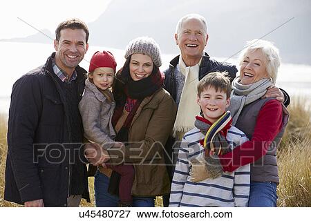 Stock Photo - Multi Generation Family In Sand Dunes On Winter Beach. Fotosearch