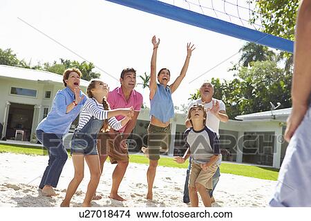 Picture - Multi Generation Family Playing Volleyball In Garden. Fotosearch