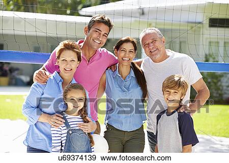 Stock Photo - Multi Generation Family Playing Volleyball In Garden. Fotosearch
