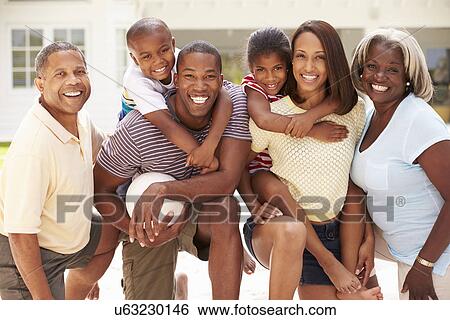 Stock Photograph - Multi Generation Family Playing Volleyball Together. Fotosearch