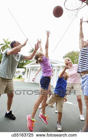 Stock Photography - Multi Generation Family Playing Basketball Together. Fotosearch