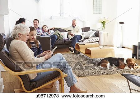Multi Generation Family Relaxing At Home Together View Large Photo Image Stock Photo - Multi Generation Family Relaxing At Home Together. Fotosearch