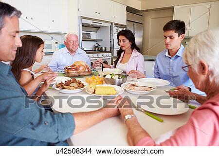 Multi-Generation Family Saying Prayer Before Eating Meal View Large Photo Image Picture - Multi-Generation Family Saying Prayer Before Eating Meal. Fotosearch