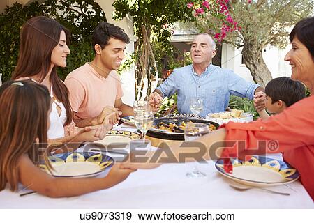 Multi Generation Family Saying Prayer Before Meal Together View Large Photo Image Stock Photo - Multi Generation Family Saying Prayer Before Meal Together. Fotosearch