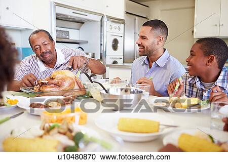 Multi-Generation Family Sitting Around Table Eating Meal View Large Photo Image Stock Image - Multi-Generation Family Sitting Around Table Eating Meal. Fotosearch