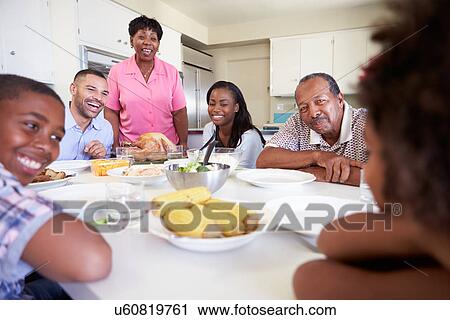 Multi-Generation Family Sitting Around Table Eating Meal View Large Photo Image Stock Image - Multi-Generation Family Sitting Around Table Eating Meal. Fotosearch