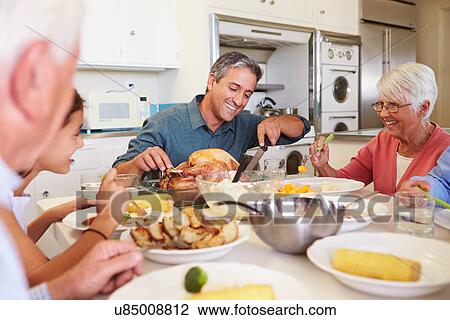 Multi-Generation Family Sitting Around Table Eating Meal View Large Photo Image Stock Image - Multi-Generation Family Sitting Around Table Eating Meal. Fotosearch