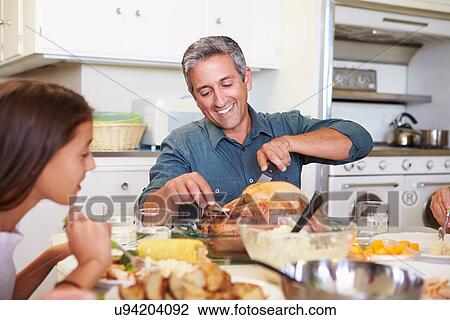Multi-Generation Family Sitting Around Table Eating Meal View Large Photo Image Stock Image - Multi-Generation Family Sitting Around Table Eating Meal. Fotosearch