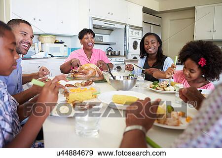 Multi-Generation Family Sitting Around Table Eating Meal View Large Photo Image Stock Photo - Multi-Generation Family Sitting Around Table Eating Meal. Fotosearch
