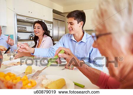 Multi-Generation Family Sitting Around Table Eating Meal View Large Photo Image Stock Photo - Multi-Generation Family Sitting Around Table Eating Meal. Fotosearch