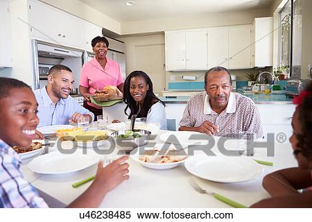 Multi-Generation Family Sitting Around Table Eating Meal View Large Photo Image Stock Photography - Multi-Generation Family Sitting Around Table Eating Meal. Fotosearch