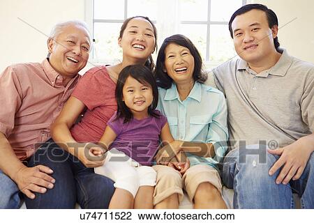 Multi Generation Family Sitting On Sofa At Home Together View Large Photo Image Stock Image - Multi Generation Family Sitting On Sofa At Home Together. Fotosearch