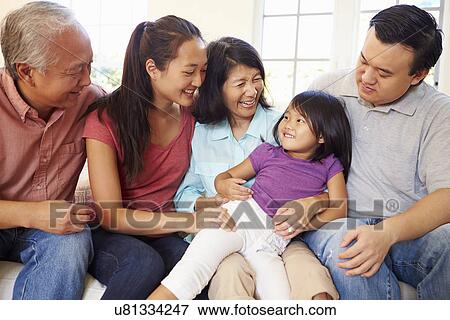Multi Generation Family Sitting On Sofa At Home Together View Large Photo Image Stock Photo - Multi Generation Family Sitting On Sofa At Home Together. Fotosearch