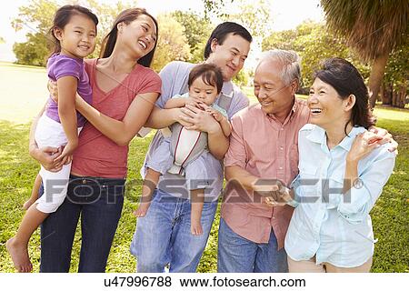 Multi Generation Family Walking In Park Together View Large Photo Image Stock Photo - Multi Generation Family Walking In Park Together. Fotosearch