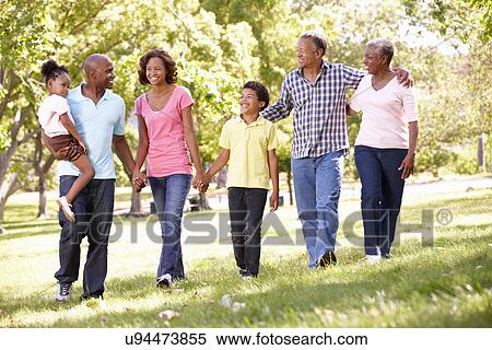Multi-generation family walking in park View Large Photo Image Stock Photography - Multi-generation family walking in park. Fotosearch