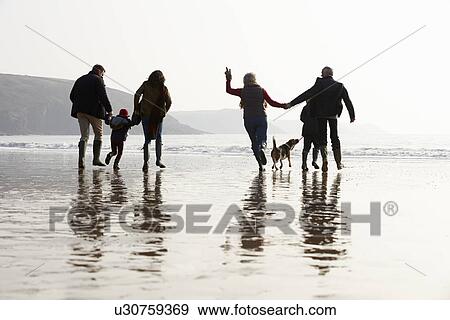Multi Generation Family Walking On Winter Beach With Dog View Large Photo Image Stock Photo - Multi Generation Family Walking On Winter Beach With Dog. Fotosearch