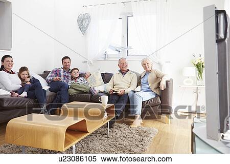 Multi Generation Family Watching TV Together View Large Photo Image Stock Photography - Multi Generation Family Watching TV Together. Fotosearch