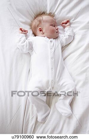 Newborn Baby Girl Sleeping In Bed View Large Photo Image Stock Image - Newborn Baby Girl Sleeping In Bed. Fotosearch