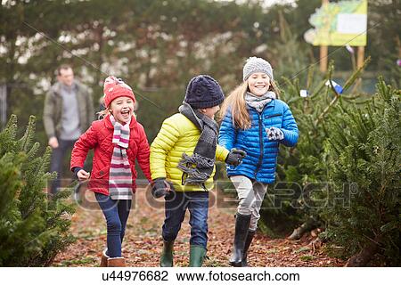 Outdoor Family Choosing Christmas Tree Together View Large Photo Image Stock Image - Outdoor Family Choosing Christmas Tree Together. Fotosearch