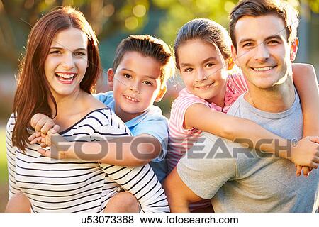 Stock Photo - Outdoor Portrait Of Family Having Fun In Park. Fotosearch
