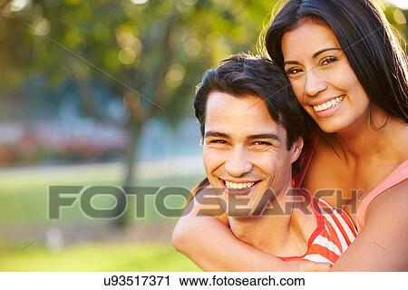 Stock Image - Outdoor Portrait Of Romantic Young Couple In Park. Fotosearch
