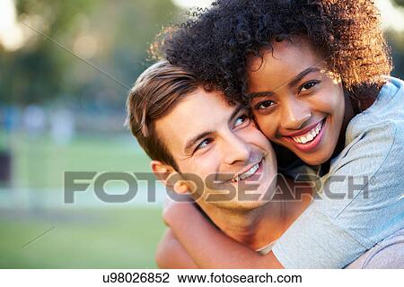 Outdoor Portrait Of Romantic Young Couple In Park View Large Photo Image Stock Image - Outdoor Portrait Of Romantic Young Couple In Park. Fotosearch