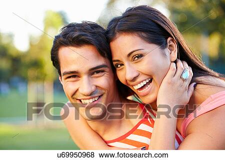 Outdoor Portrait Of Romantic Young Couple In Park View Large Photo Image Stock Photo - Outdoor Portrait Of Romantic Young Couple In Park. Fotosearch