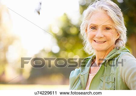 Stock Image - Outdoor Portrait Of Smiling Senior Woman. Fotosearch
