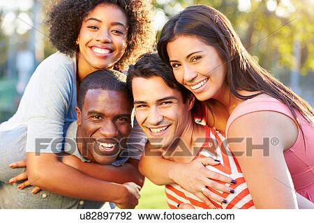 Stock Image - Outdoor Portrait Of Young Friends Having Fun In Park. Fotosearch