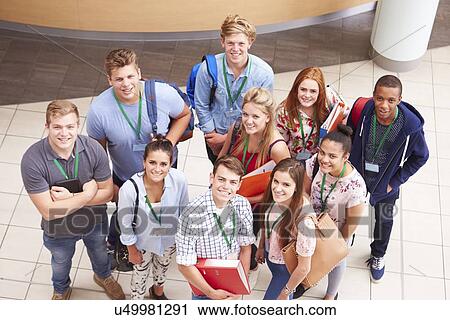 Stock Image - Overhead Portrait Of College Students Standing In Hallway. Fotosearch