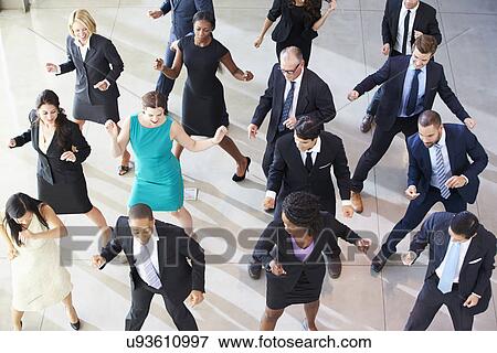 Stock Photo - Overhead View Of Businesspeople Dancing In Office Lobby. Fotosearch