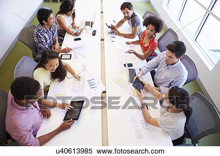 Overhead View Of Designers Meeting To Discuss New Ideas View Large Photo Image Stock Photography - Overhead View Of Designers Meeting To Discuss New Ideas. Fotosearch