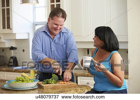 Overweight Couple On Diet Preparing Vegetables In Kitchen View Large Photo Image Stock Photo - Overweight Couple On Diet Preparing Vegetables In Kitchen. Fotosearch