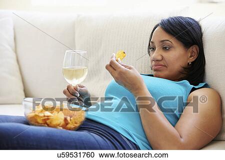 Overweight Woman At Home Eating Chips And Drinking Wine View Large Photo Image Stock Image - Overweight Woman At Home Eating Chips And Drinking Wine. Fotosearch