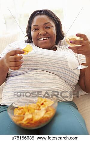Overweight Woman At Home Eating Chips And Drinking Wine View Large Photo Image Stock Photography - Overweight Woman At Home Eating Chips And Drinking Wine. Fotosearch