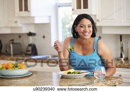 Overweight Woman Eating Healthy Meal in Kitchen View Large Photo Image Stock Image - Overweight Woman Eating Healthy Meal in Kitchen. Fotosearch
